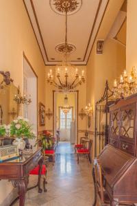 a large living room with a chandelier and a piano at La Villa Teresa in Havana