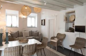a living room with a couch and a table and chairs at Apollonion house in Apollonia