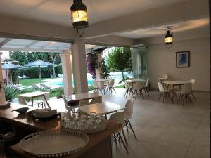 a restaurant with tables and chairs and a patio at Satori Boutique Hotel in Acharavi
