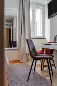 Televízia a/alebo spoločenská miestnosť v ubytovaní Casa Carminatti Apartments