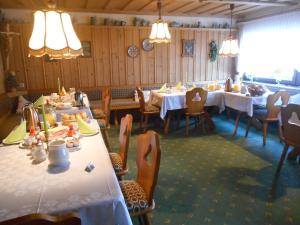 a dining room with tables and chairs and lights at Pension Sonnenblick in Winterberg +54 photos