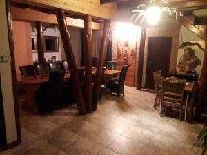 a dining room with a table and chairs at Casa DAOS in Nucşoara