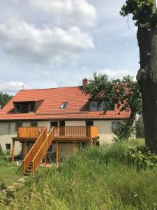 a house with a staircase in front of it at Agroturystyka Zacisze in Maciejowiec