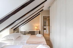 Posteľ alebo postele v izbe v ubytovaní Casa Carminatti Apartments