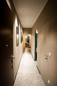 a hallway with two doors and a room with a table at Torino48 Guesthouse in Milan