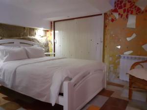 A bed or beds in a room at Hostal Casa Martinez