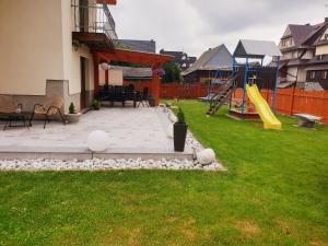 a backyard with a playground with a slide at u Sabiny in Białka Tatrzańska
