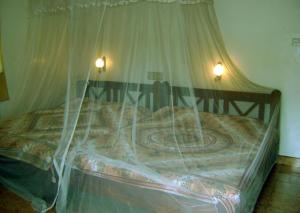 A bed or beds in a room at Palm Garden Home Stay