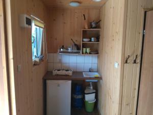 a kitchen with a counter and a sink in a room at domki pestka in Jastrzębia Góra