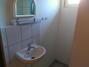 a bathroom with a sink and a mirror at domki pestka in Jastrzębia Góra
