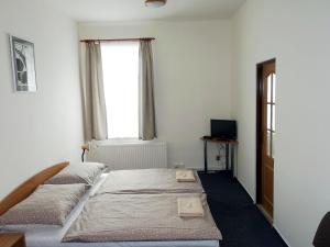 Postel nebo postele na pokoji v ubytování HOTEL STAŘÍČ