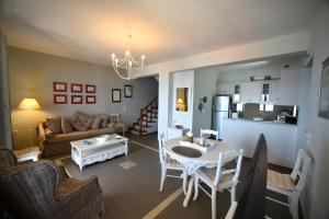 a living room with a couch and a table at Heliades Maisonettes in Mythimna