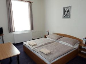 Postel nebo postele na pokoji v ubytování HOTEL STAŘÍČ