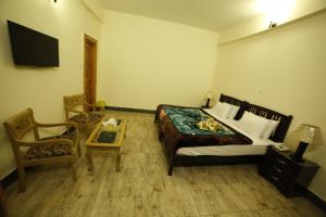 Postel nebo postele na pokoji v ubytování Chinar Resorts