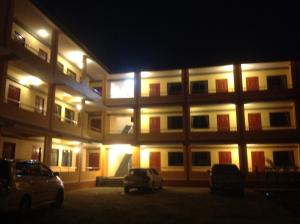 a building with cars parked in front of it at night at Sapan Residence in Chiang Mai