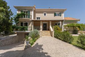 a house with a stone driveway in front of it at Ethereal Villa in Mouzákion