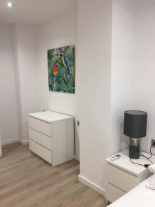 a bedroom with a desk and a painting on the wall at Garden Turia Downtown in Valencia