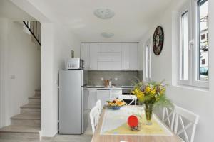 a kitchen with a table and a refrigerator at Hajdi in Kamenari