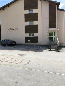 a building with a car parked in front of it at Wohnung Gstein C4 in Leukerbad