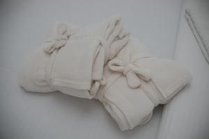 a stack of white towels on a wall at City Holliday Lux in Belgrade +64 photos