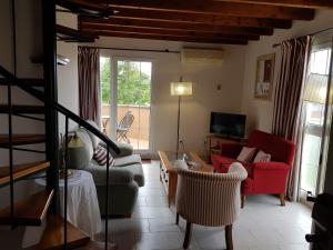 a living room with a couch and a table at Apartamentos Hacienda de Arna in Somo