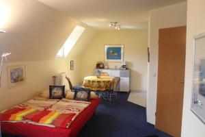 a room with two beds and a table in it at Fährhaus Ferienwohnung in Saarburg