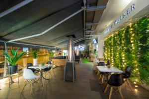 a restaurant with tables and chairs and plants at TRYP by Wyndham Cuenca Zahir in Cuenca