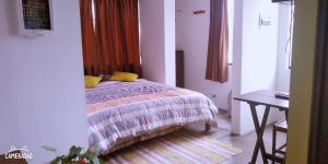 a bedroom with a bed and a table in it at La Casa del Che Fernando in Lima