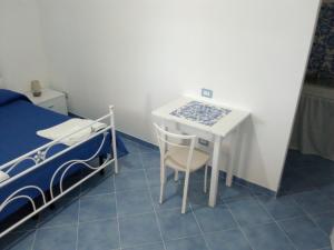 a small room with a bed and a table and a bed at Angel home in Malfa