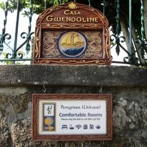 a sign on a wall next to a iron fence at Casa Gwendoline - Albergue / Hostel / AL - Caminho da Costa in Vila Nova de Cerveira