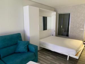 a small bedroom with a bed and a couch at Cap Salou Zeus in Salou +40 photos