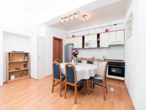 a kitchen and dining room with a table and chairs at Apartments Niko in Lokva Rogoznica