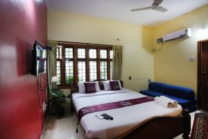 Letto o letti in una camera di LikeMyHome Homestay Mysore