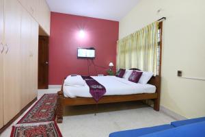 Letto o letti in una camera di LikeMyHome Homestay Mysore