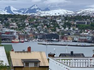 a view of a city with snow covered mountains at FIVE Apartments in Tromsø