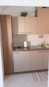 a kitchen with white cabinets and a sink at Apartment Marina in Valun