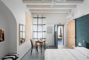 a bedroom with a desk and a bed and a table at Apartments & Rooms Carera 6 in Rovinj +38 photos