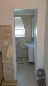 a small bathroom with a sink and a toilet at Apartment Marina in Valun +19 photos