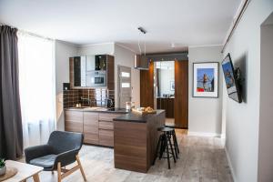 a kitchen with a island in the middle of a room at Apartamenty Pocztowa in Bydgoszcz