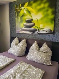 a picture of rocks and pillows on a bed at Ferienwohnung Naturnah in Goslar