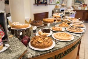 a table filled with lots of different types of pastries at Hotel Villa Tiziana in Marina di Massa