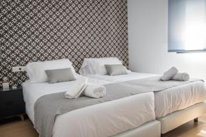 Posteľ alebo postele v izbe v ubytovaní Ibericabeds Granada