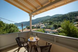 a balcony with a table and chairs and a view at Odyssey Hotel in Agios Nikitas