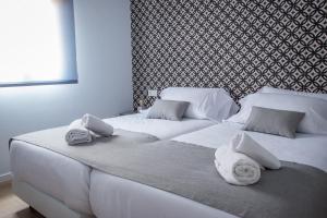 Posteľ alebo postele v izbe v ubytovaní Ibericabeds Granada