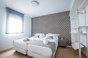 Posteľ alebo postele v izbe v ubytovaní Ibericabeds Granada