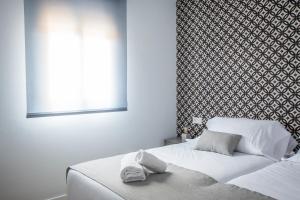 Posteľ alebo postele v izbe v ubytovaní Ibericabeds Granada