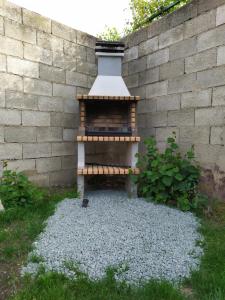 a brick wall with a fire place in a yard at Casa Rural Villa de Ambel in Ambel