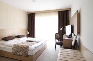 En eller flere senger på et rom på Hotel Mangart