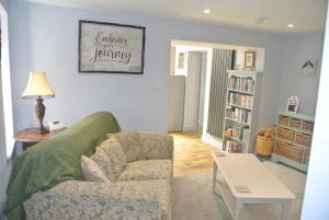 a living room with a couch and a chair at Higher Brockwell Annexe in Wootton Courtenay