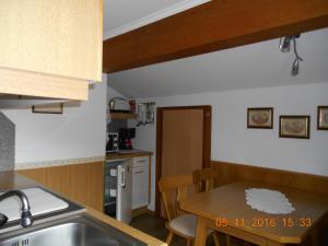 a kitchen with a sink and a wooden table at Haus Elisabeth in Tux